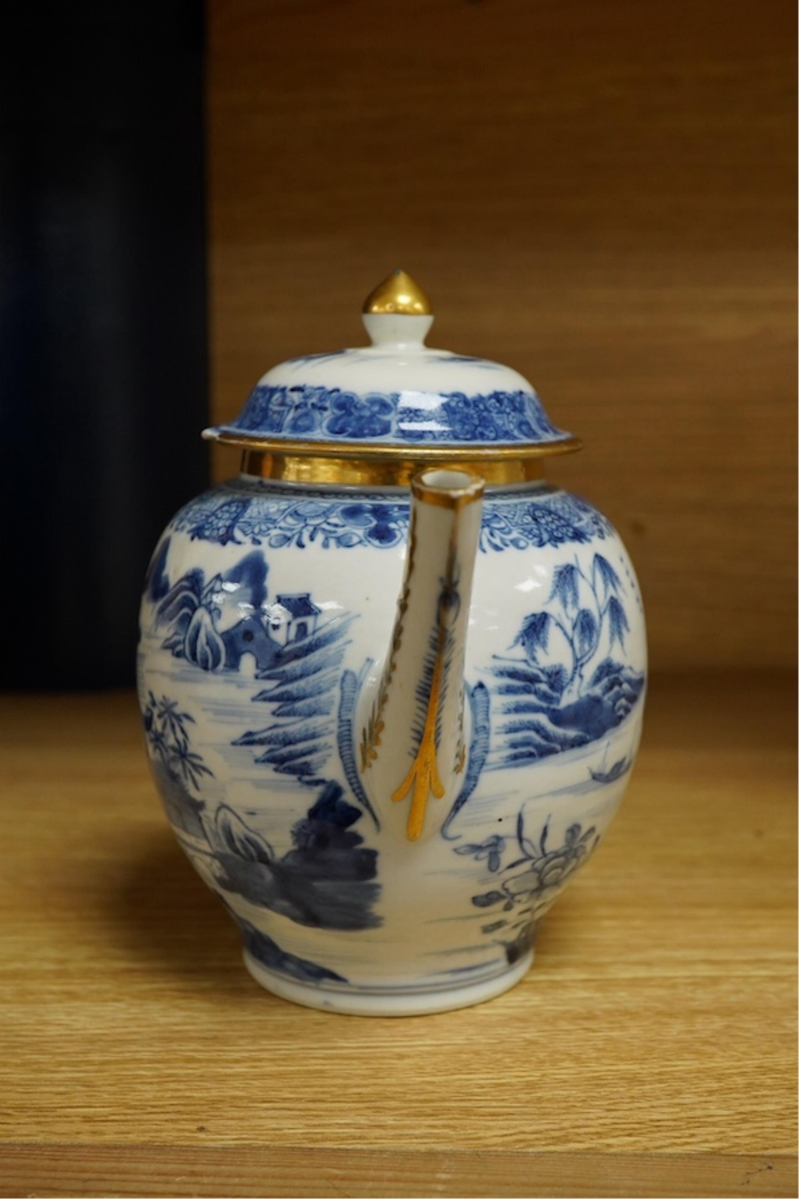 A Chinese export blue and white teapot, c.1790, painted with pagodas, 24cm wide. Condition - some chipping and firing cracks